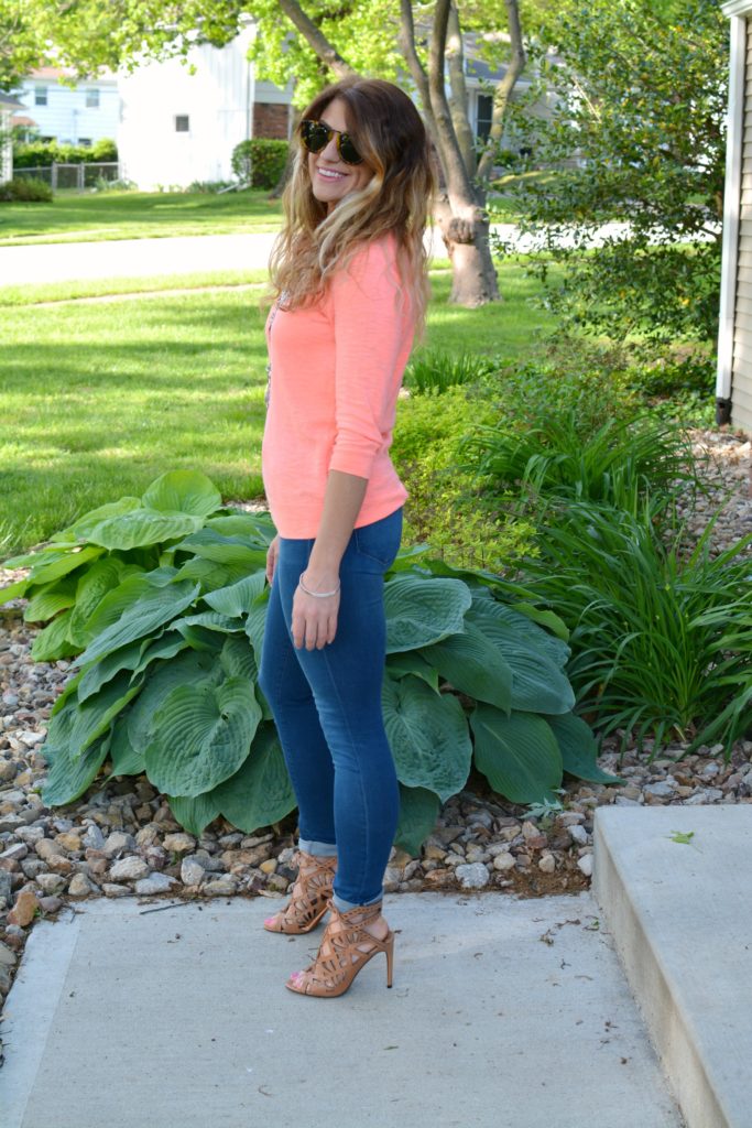 Ashley from LSR in a neon coral sweater and a silver statement necklace