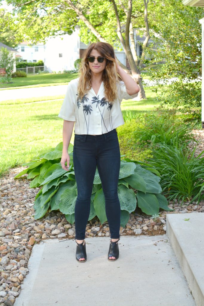 Ashley from LSR in a palm tree crop top, Frame jeans, and black mules