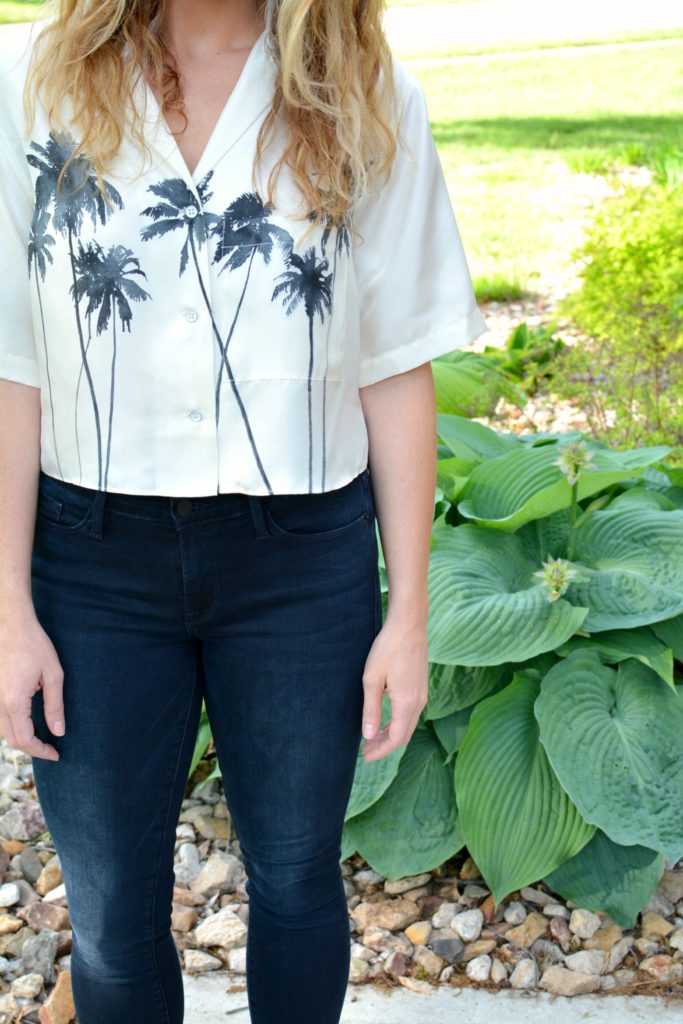 Ashley from LSR in a palm tree crop top and Frame jeans