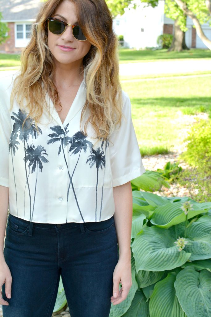 Ashley from LSR in a palm tree crop top and Frame jeans