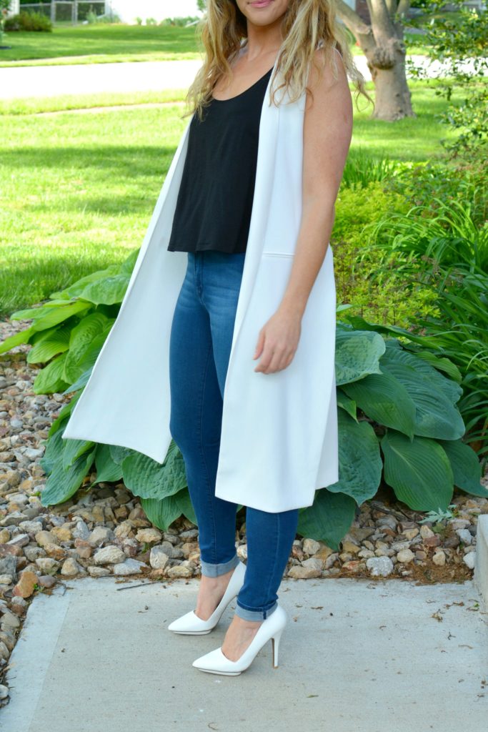 Ashley from LSR in a long white vest and white pumps