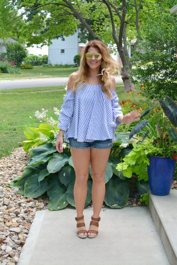 Ashley from LSR in an off-the-shoulder striped top, jean shorts, and wedges