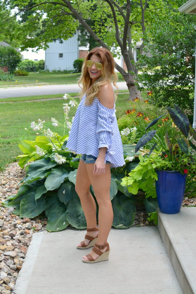 Ashley from LSR in an off-the-shoulder striped top, jean shorts, and wedges