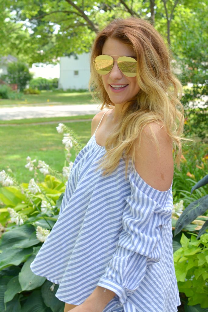 Ashley from LSR in an off-the-shoulder striped top and rose gold aviator sunglasses