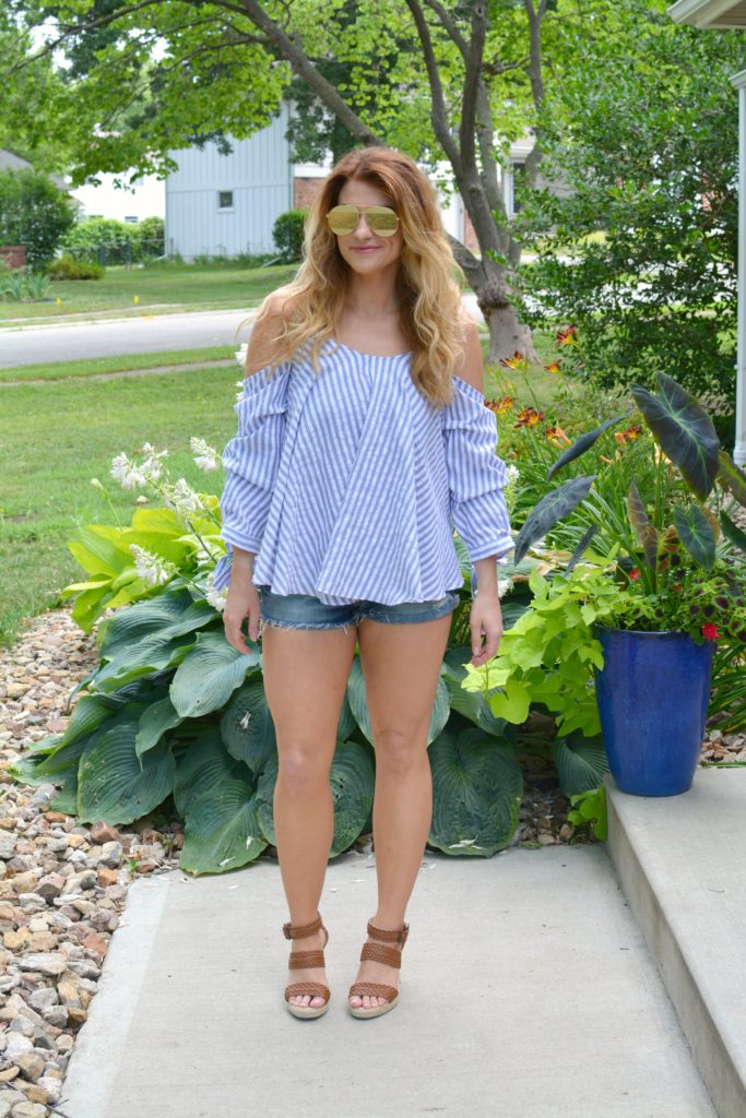 Ashley from LSR in an off-the-shoulder striped top, jean shorts, and wedges