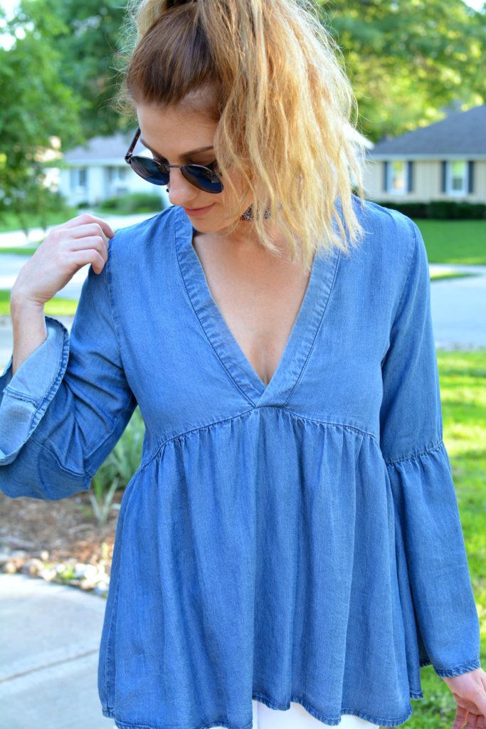 Ashley from LSR in a denim peasant top and round sunglasses