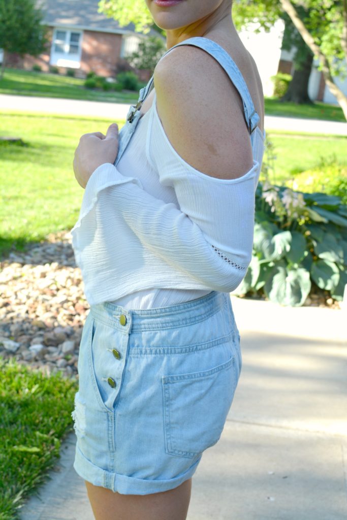 Ashley from LSR in overall shorts and a white tunic