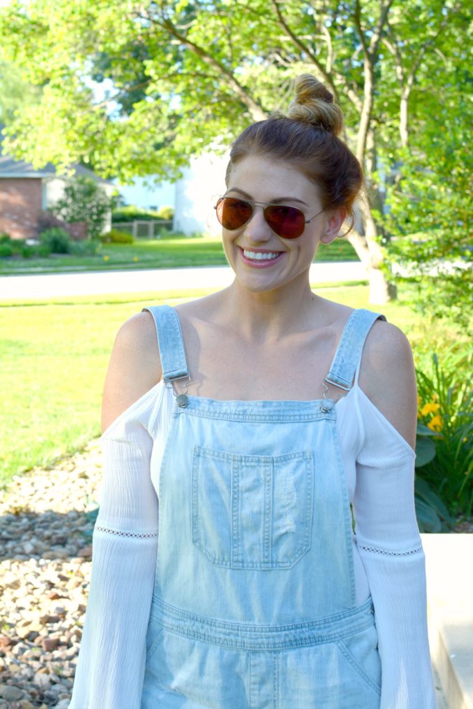 Ashley from LSR in overall shorts and a white tunic