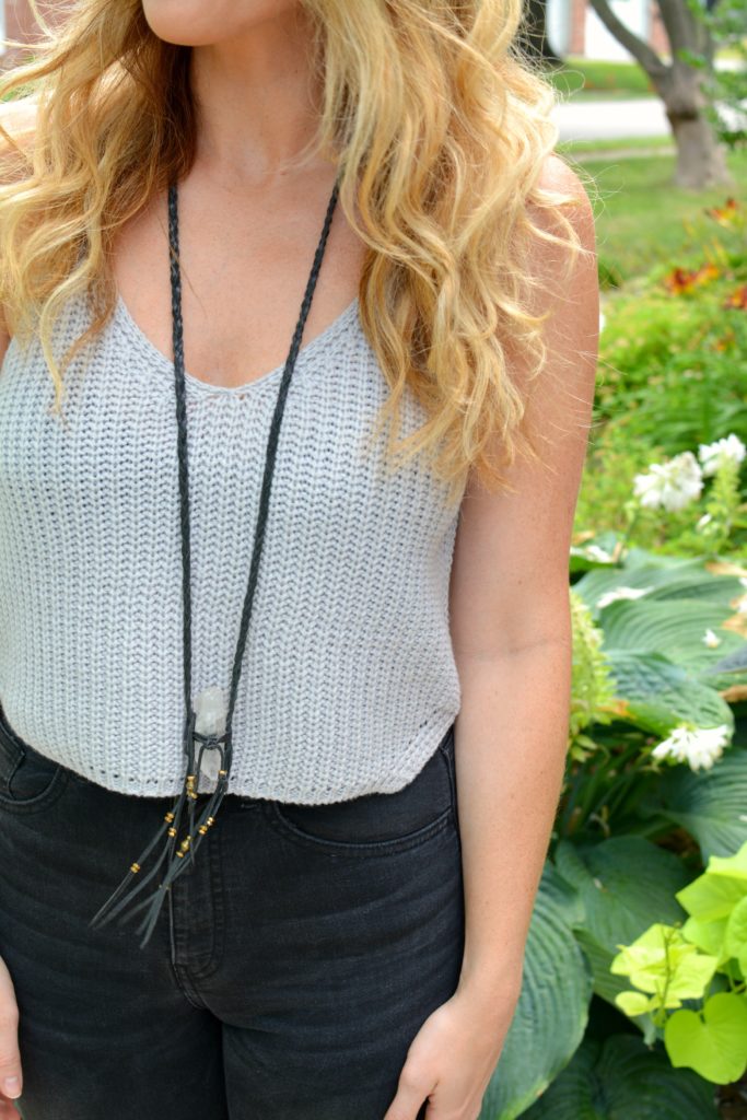 Ashley from LSR in a gray cropped sweater tank and clear quartz necklace