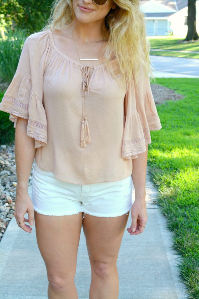 Ashley from LSR in a blush top from Zara and white denim shorts