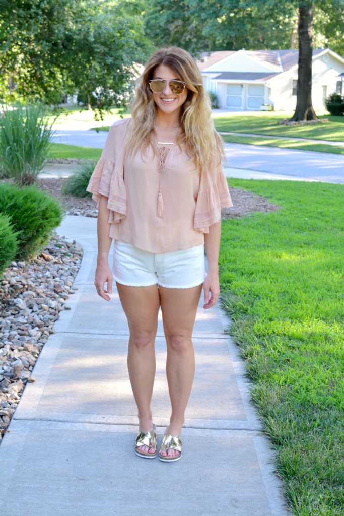Ashley from LSR in a blush top from Zara, white denim shorts, and metallic slides