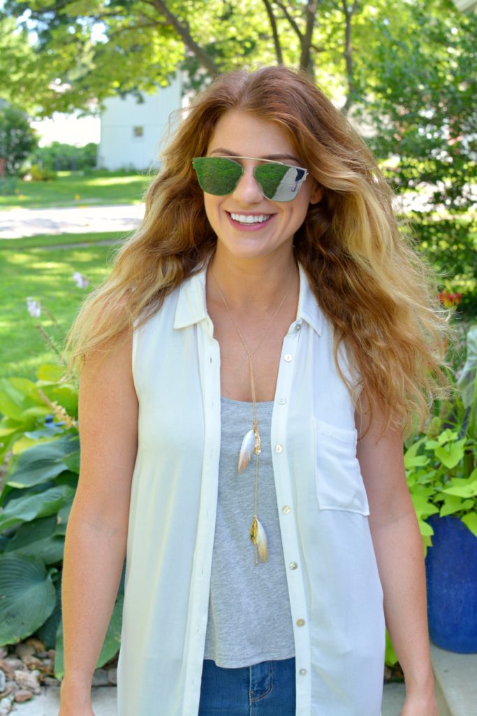 Ashley from LSR in a white duster and mirrored Zero UV sunglasses