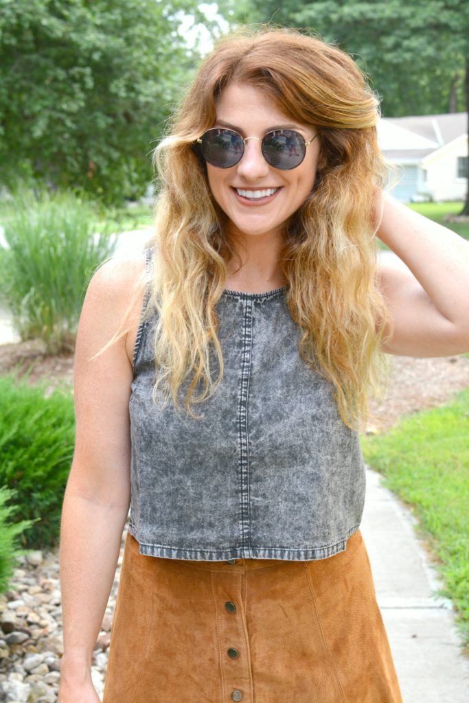 Ashley from LSR in an acid wash crop top and round sunglasses