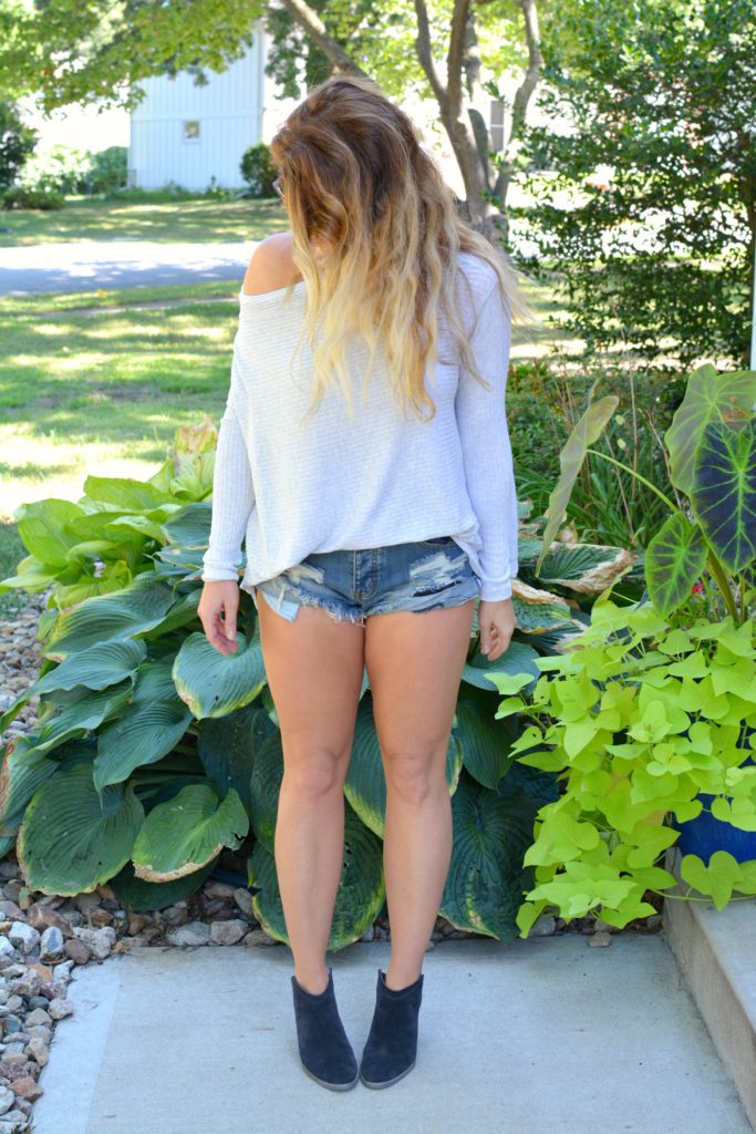 Ashley from LSR wearing a lightweight sweater, One Teaspoon shorts, and ankle boots