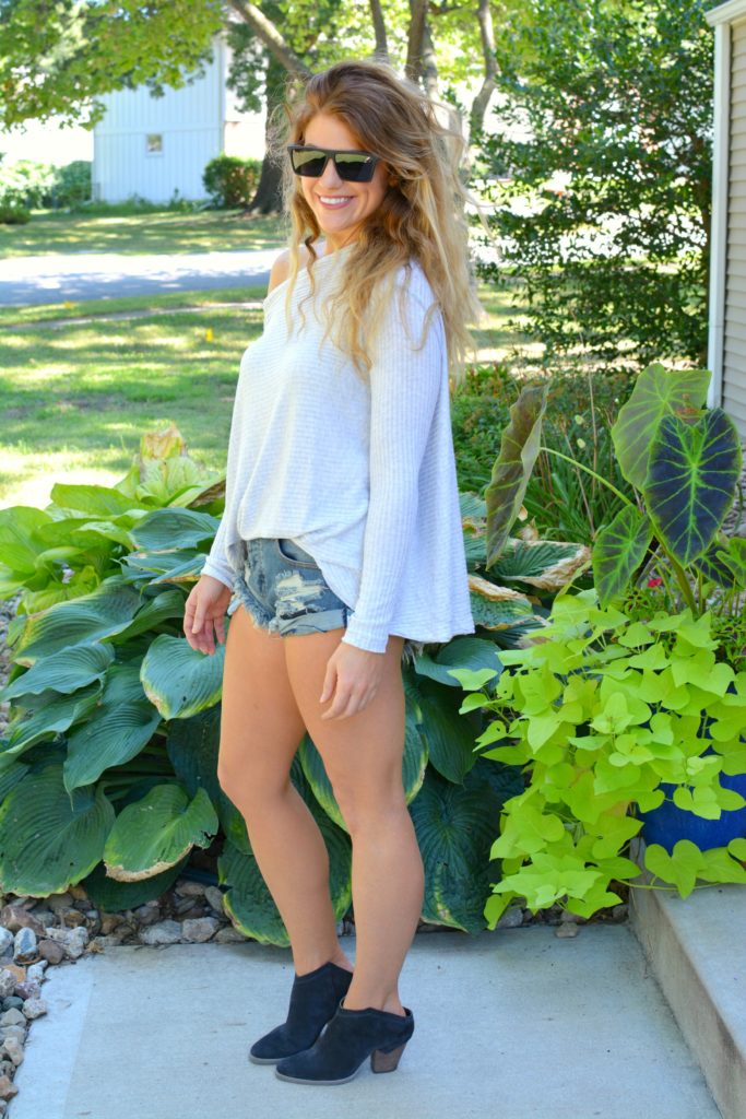 Ashley from LSR wearing a lightweight sweater, One Teaspoon shorts, and ankle boots