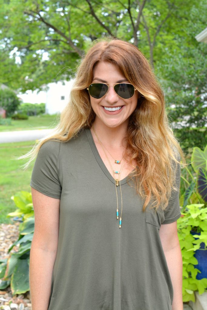 Ashley from LSR in an olive green tee and House of Harlow necklaces