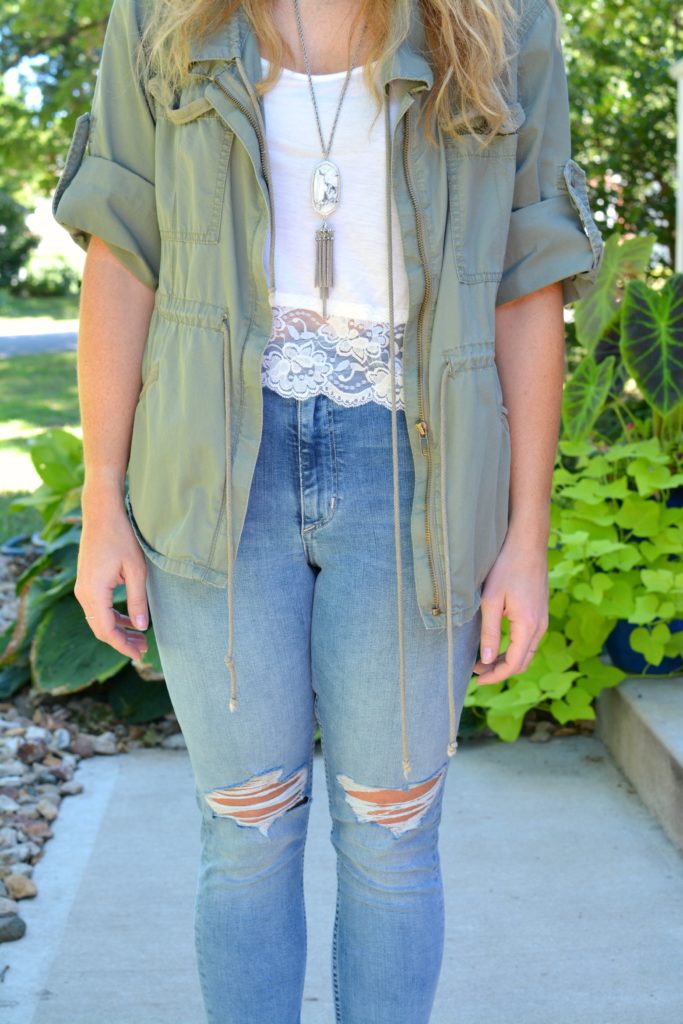Ashley from LSR in an olive green utility jacket and destroyed denim