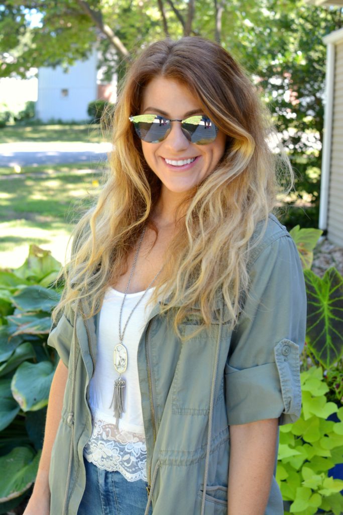 Ashley from LSR in an olive green utility jacket, destroyed denim, and Fendi sunglasses