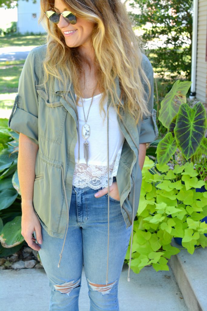 Ashley from LSR in an olive green utility jacket, destroyed denim, and Fendi sunglasses