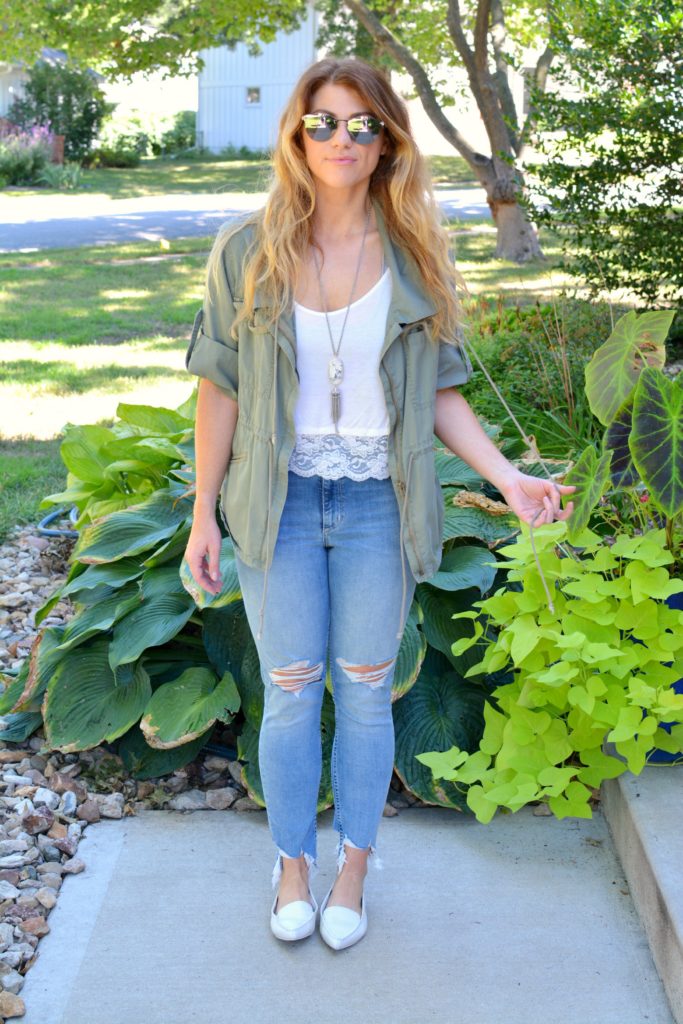 Ashley from LSR in an olive green utility jacket, destroyed denim, white loafers, and Fendi sunglasses