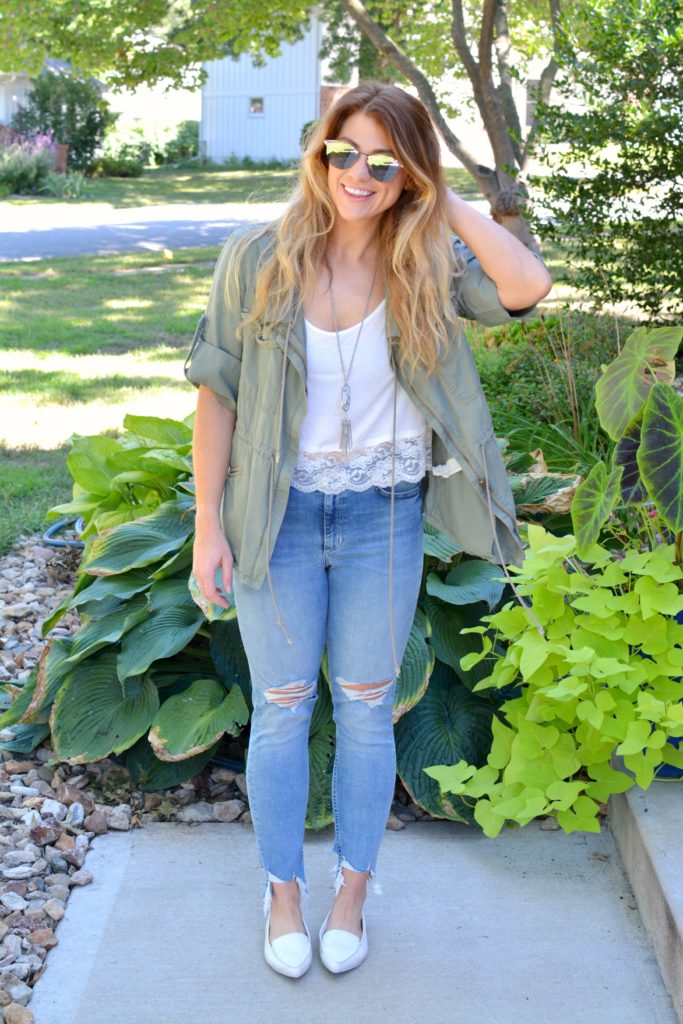 Ashley from LSR in an olive green utility jacket, destroyed denim, white loafers, and Fendi sunglasses