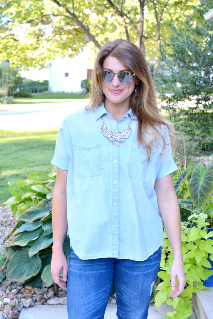 Ashley from LSR in a light chambray shirt and a statement necklace