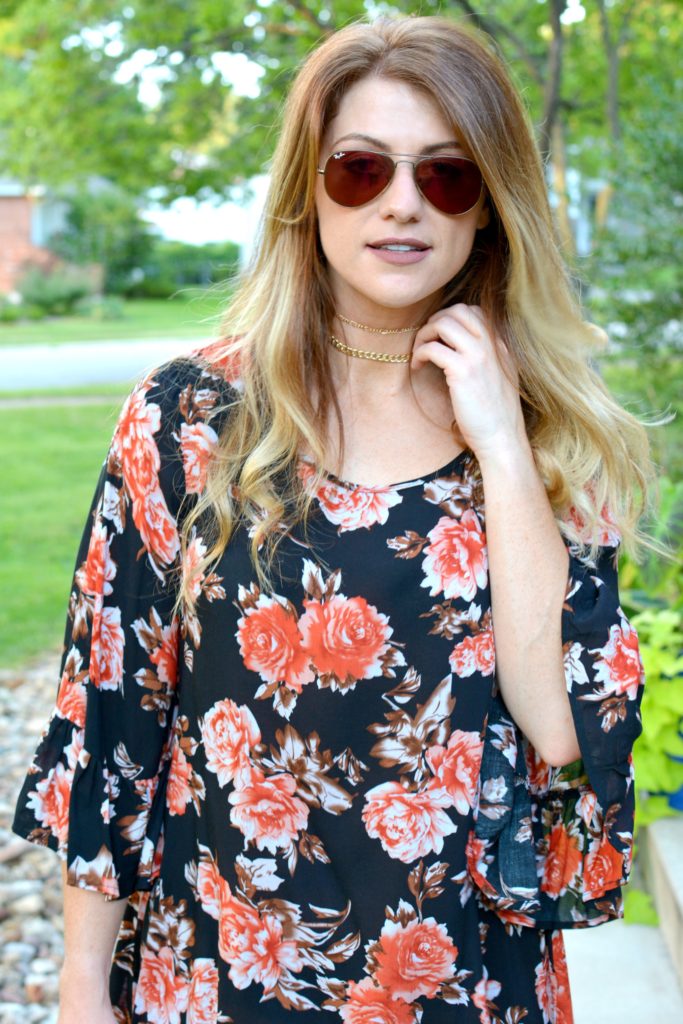 Ashley from LSR in a dark floral dress and a choker set