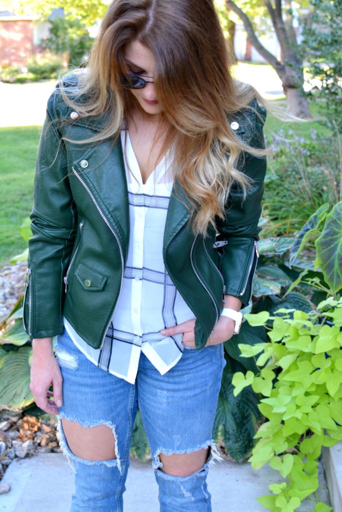Ashley from LSR in a green leather jacket and a sheer windowpane blouse