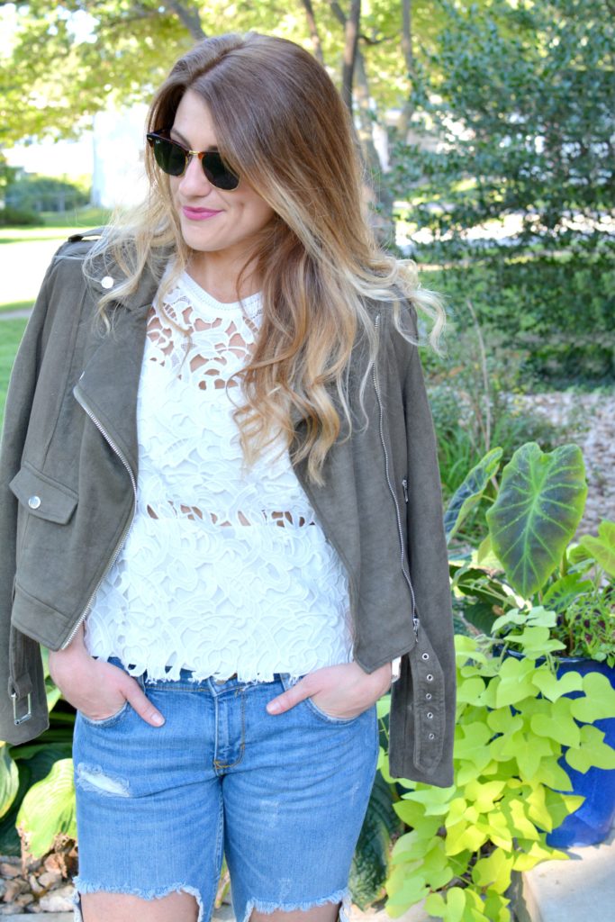 Ashley from LSR in a suede jacket, lace top, and destroyed jeans