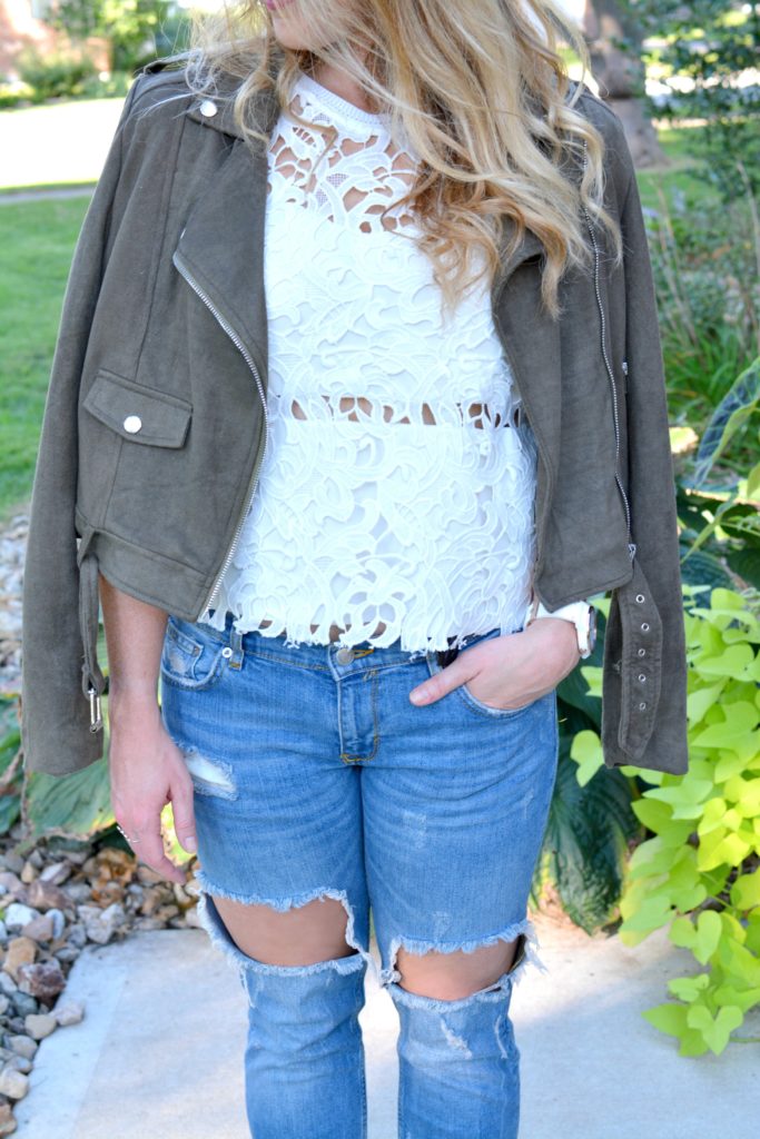Ashley from LSR in a suede jacket, lace top, and destroyed jeans