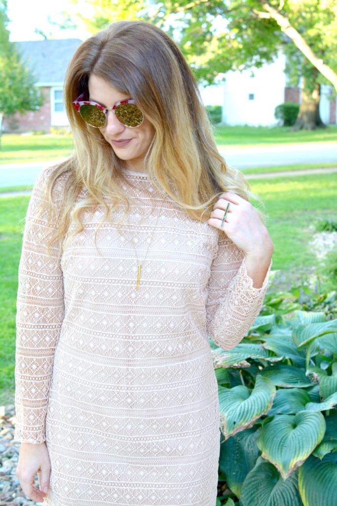 Ashley from LSR in a nude lace dress and over-sized sunglasses