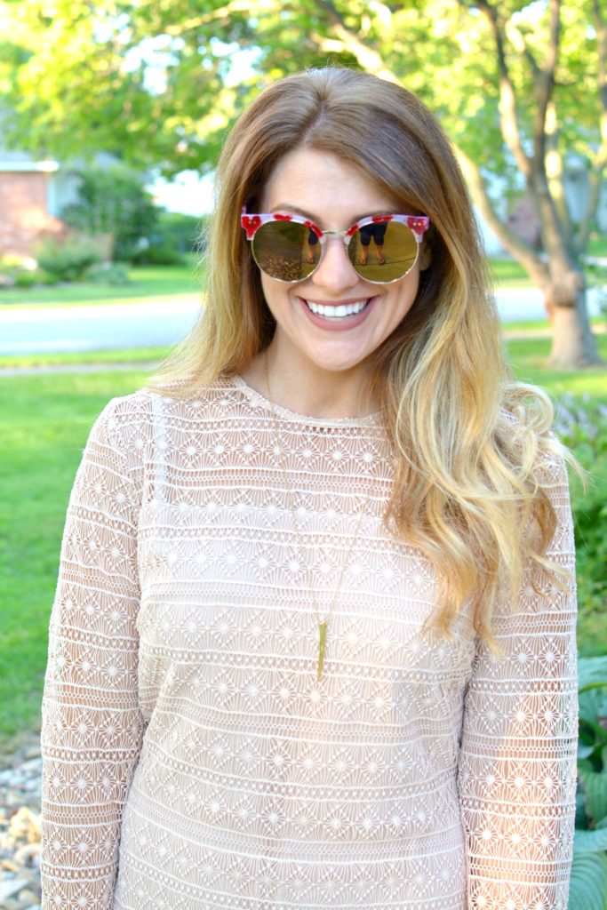 Ashley from LSR in a nude lace dress and over-sized sunglasses