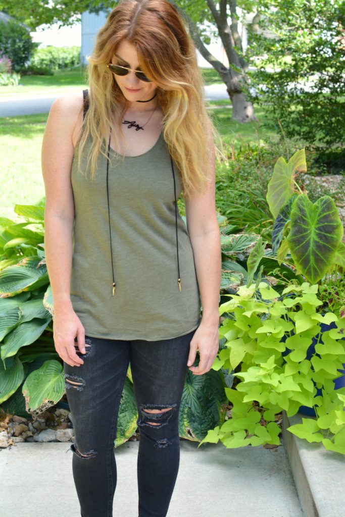 Ashley from LSR in black shredded jeans and an olive green tank with a Vanessa Mooney choker