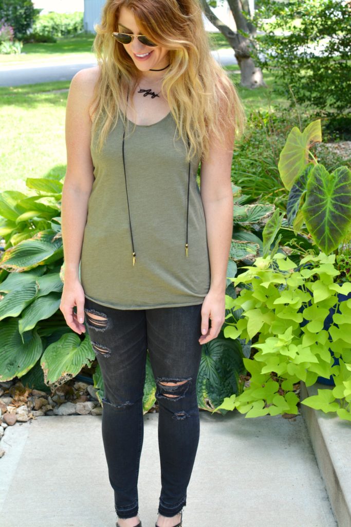 Ashley from LSR in black shredded jeans and an olive green tank with a Vanessa Mooney choker