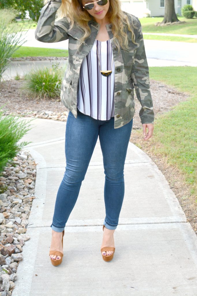 Ashley from LSR in a camo jacket, striped tank, and platform sandals