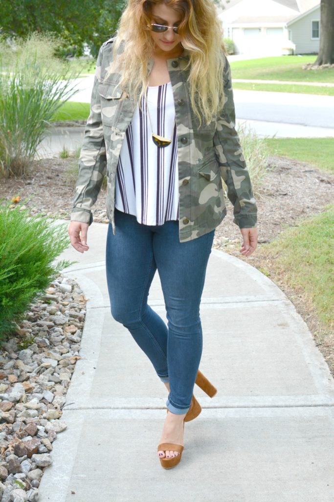 Ashley from LSR in a camo jacket, striped tank, and platform sandals
