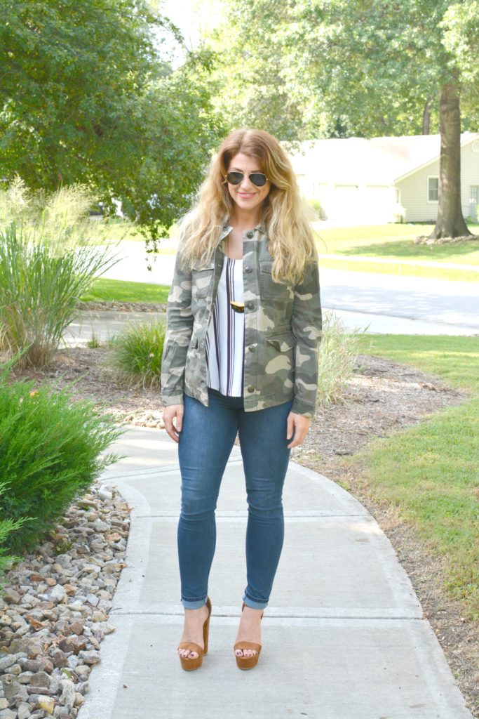 Ashley from LSR in a camo jacket, striped tank, and platform sandals