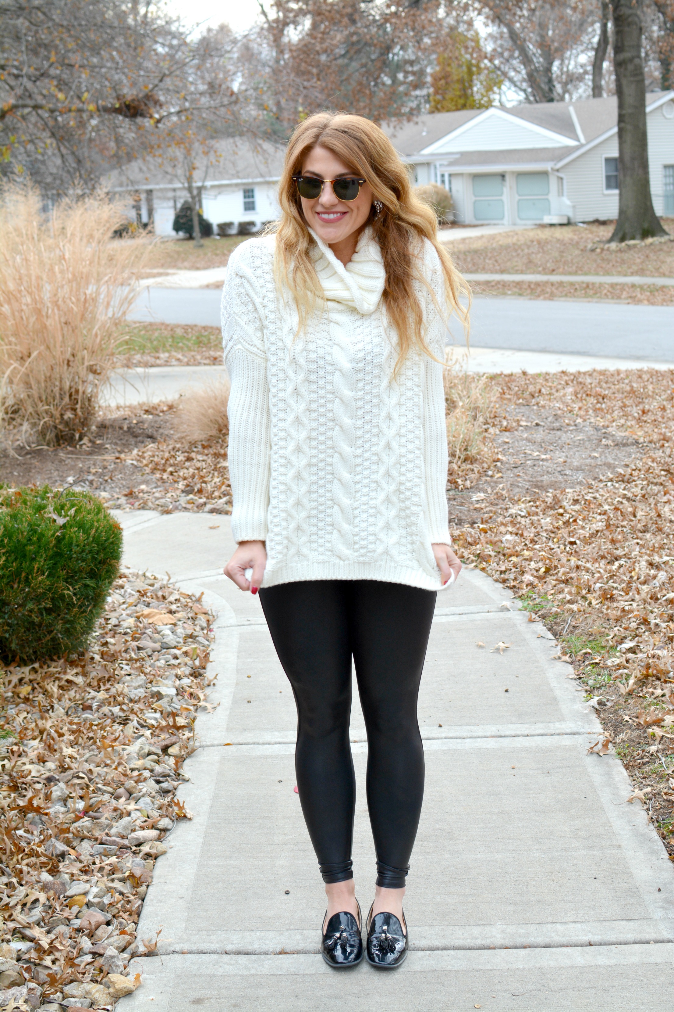 Ashley from LSR in an ivory cable knit sweater, Spanx leggings, and patent leather loafers
